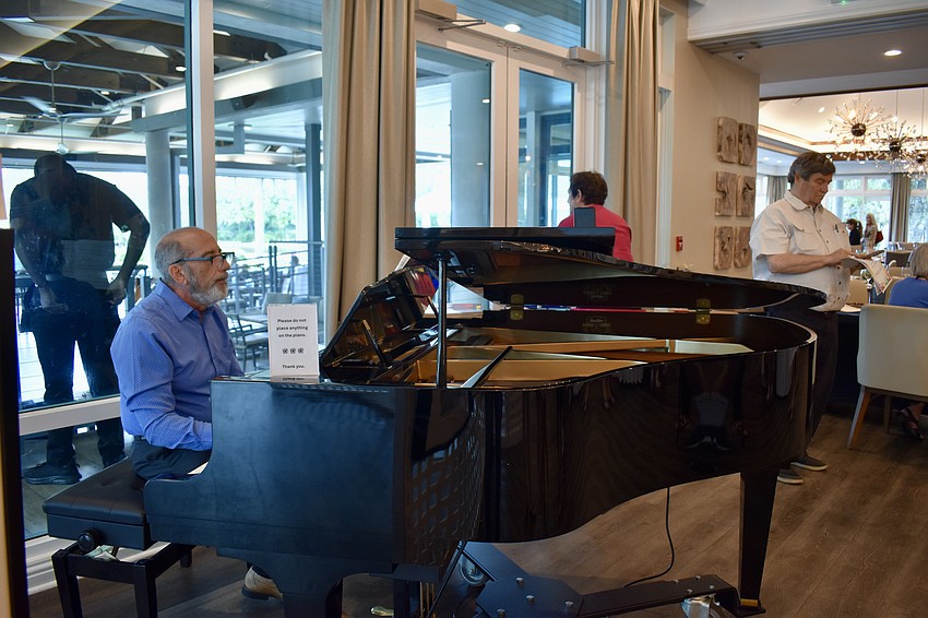 Fred Snyder plays the piano during Art in the Park on March 16.