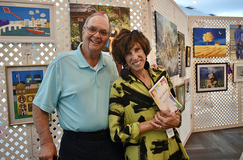 Mike Zuckerman is just looking, but Deborah Van Brunt is one of the organizers and artists displaying work at Art in the Park.