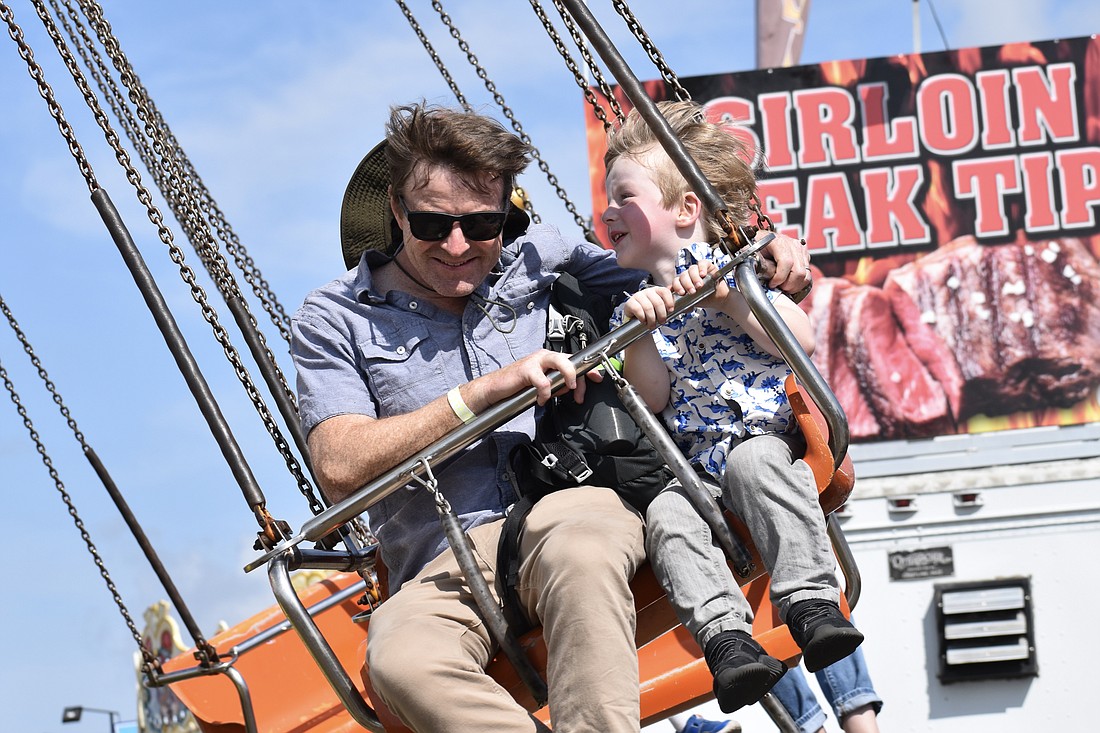 Glenn and Arlo Darling, 4, enjoy spending time together while flying through the air.