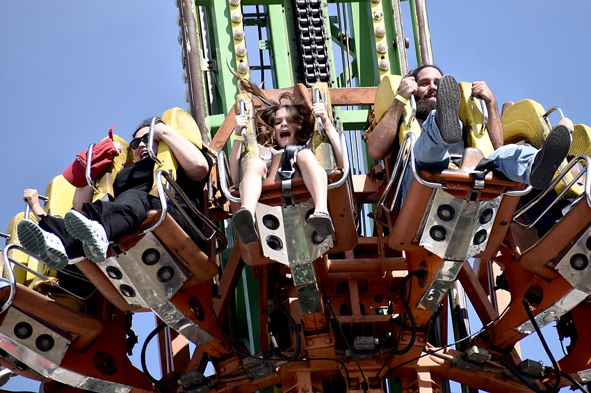 The drop tower descends, with Bradenton's Laila Woodall, 10 (center) on board.