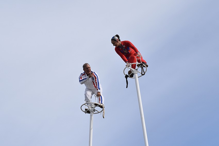 Michelangelo Nock and Erendira Wallenda prepare to switch places atop 80-foot towers during a circus performance.