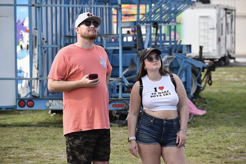 Lynden Sudweeks and Emily Nelson watch an act high in the air by the Nerveless Nocks.