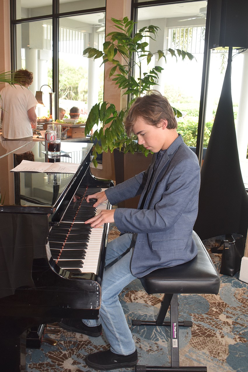 Piano prodigy Timmy Phelan, 13, played at the Chamber's Meet, Greet, Eat.