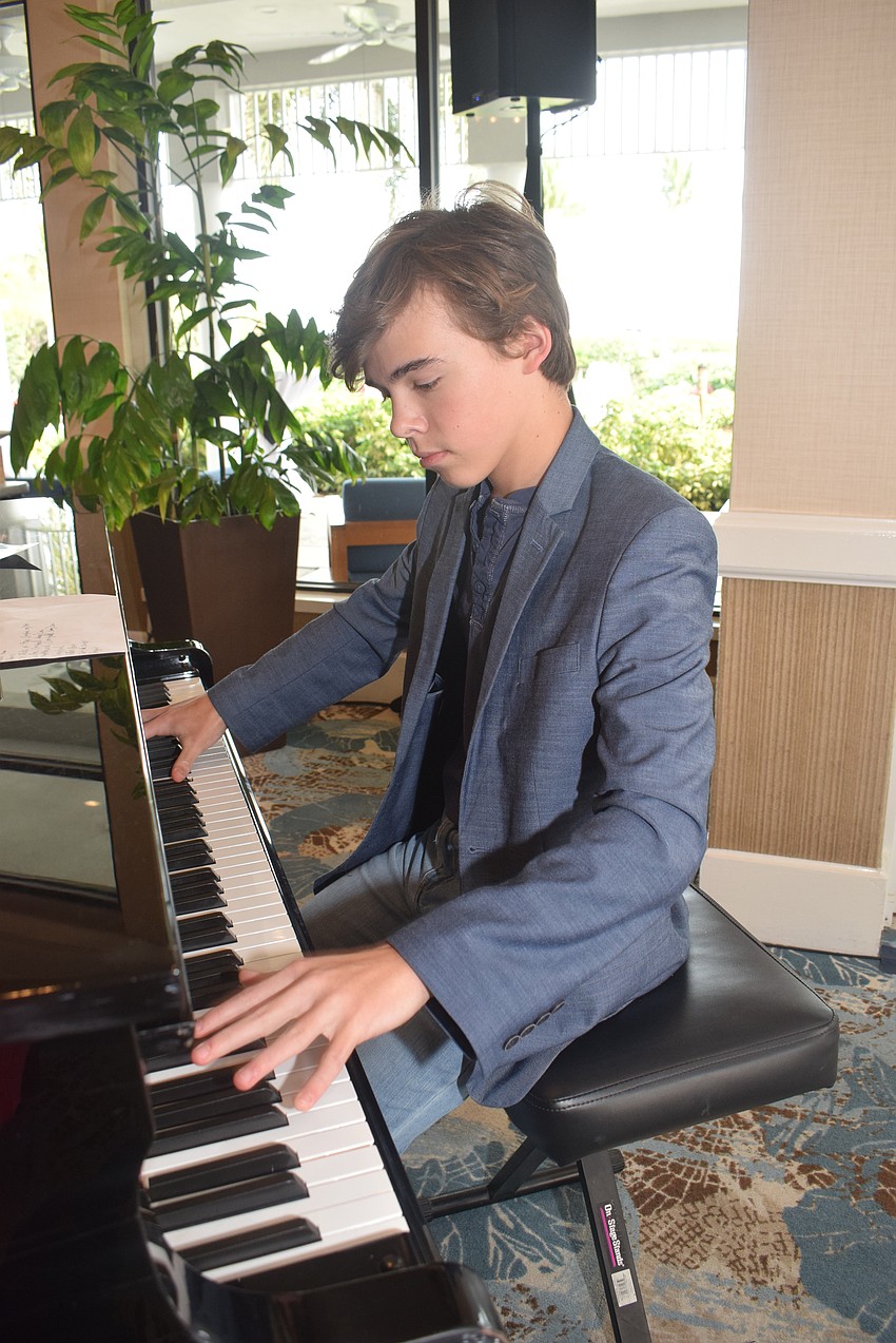 Piano prodigy Timmy Phelan, 13, played at the Chamber's Meet, Greet, Eat.