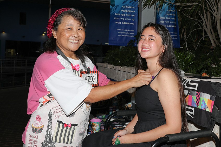 Mote Marine Laboratory and Aquarium Communications Specialist Kathryn Gentile has dolphin artwork applied by Akiko from Akiko Face Painting.
