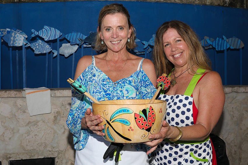 Serving Caesar salad with a special recipe dressing from Euphemia Haye on Longboat Key are Georgette Young and Dianne Page