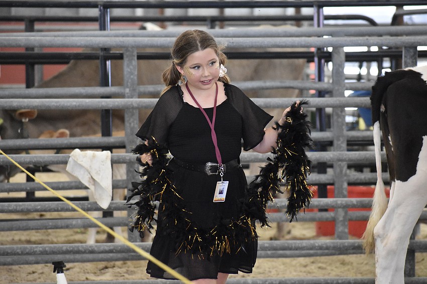 Fifth grader Sophia Sandusky brings a costume piece towards Mary Dazy.