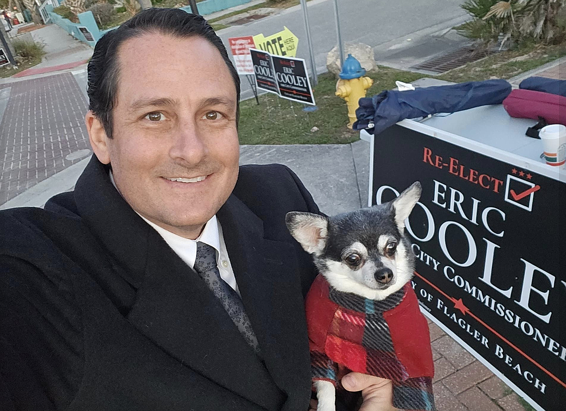 Commissioner Eric Cooley campaigning for reelection with his dog, Wednesday. Photo courtesy of Cooley