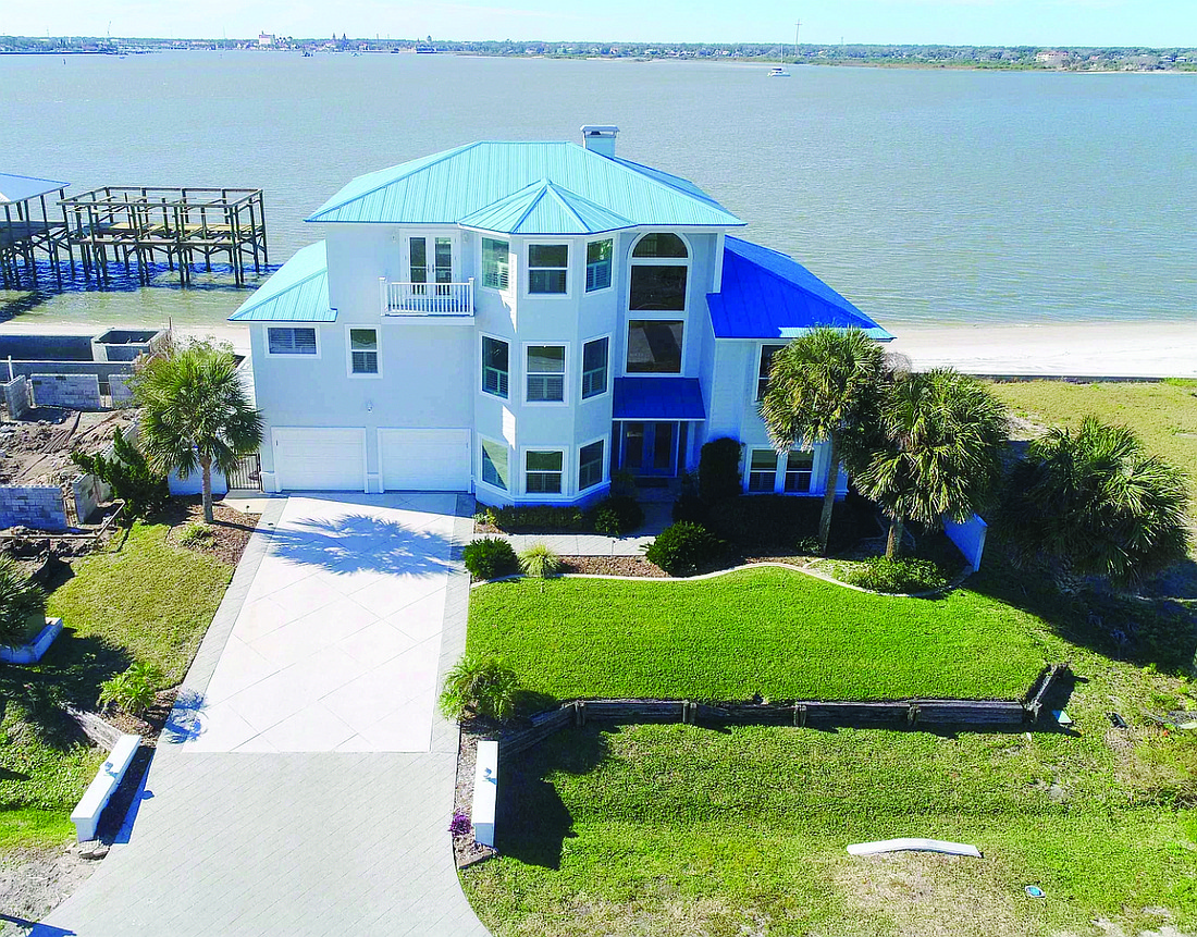 Waterfront three-story contemporary home at the St. Augustine Inlet features four bedrooms, three full and one half-bathrooms, office, game room, balconies, pool, deck and dock.