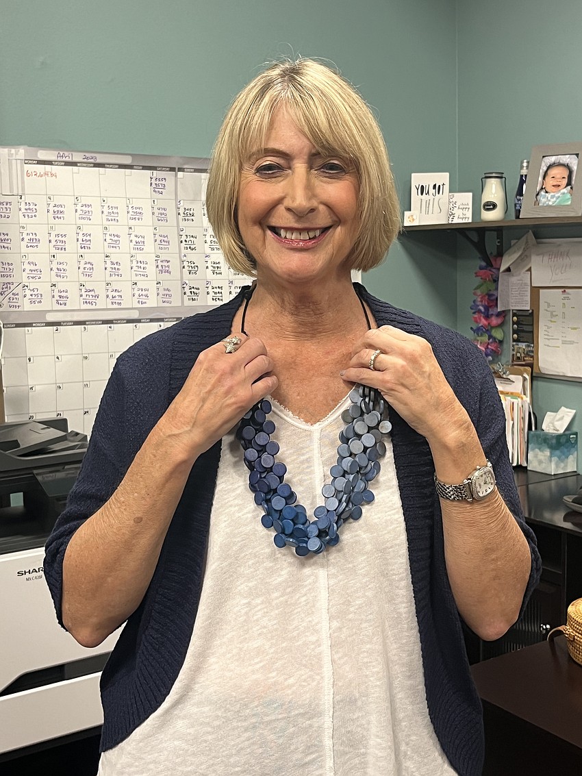 River Strand's Jean Scheuer adjusts her necklace so it's perfect for the runway.