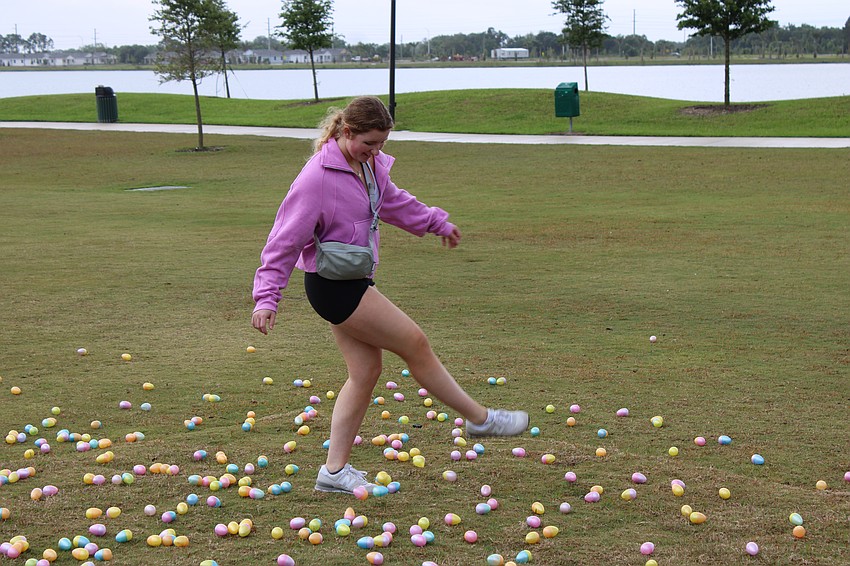 Meredith Beck uses the kick method to spread out eggs for Eggstravaganza. She was getting volunteer hours as a National Honor Society member at Lakewood Ranch High.
