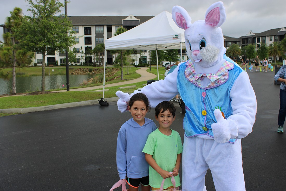 Olivia Escorcia, 7, and Marco Escorcia, 5, meet the Easter Bunny at Eggstravaganza.