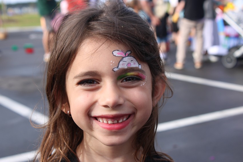 Parrish's Sofia Buccione, 6, shows off the finished product of her face painting at Eggstravaganza.