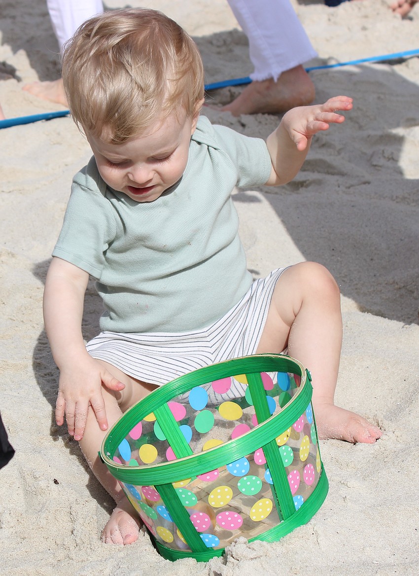 Waterside 18-month-old August Smith checks out the eggs he scooped up at Eggstravaganza.