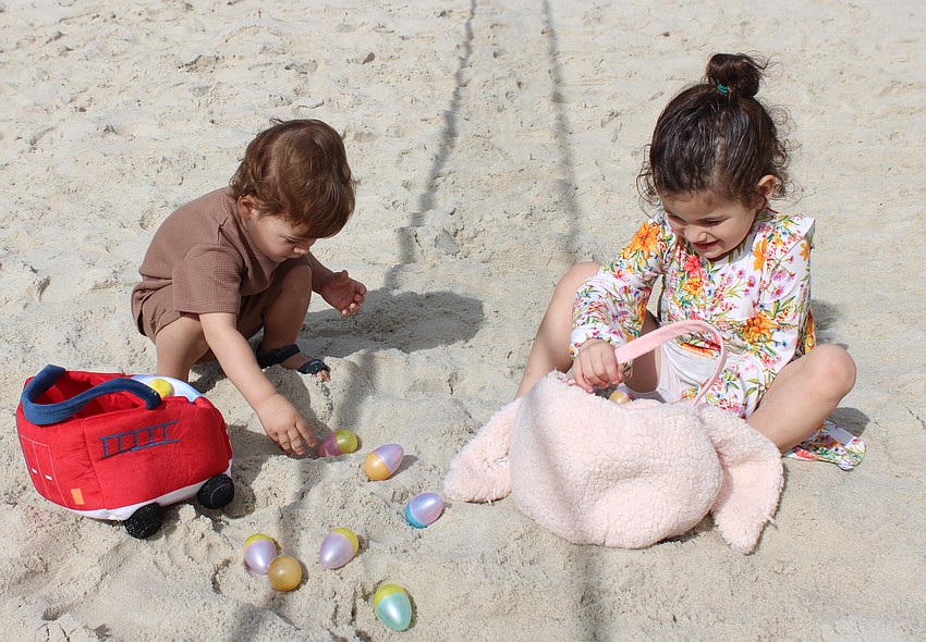 Lakewood Ranch's Kaden Stalnaker, 2, and Savannah Stalnaker, 4, begin to open their eggs at Eggstravaganza.
