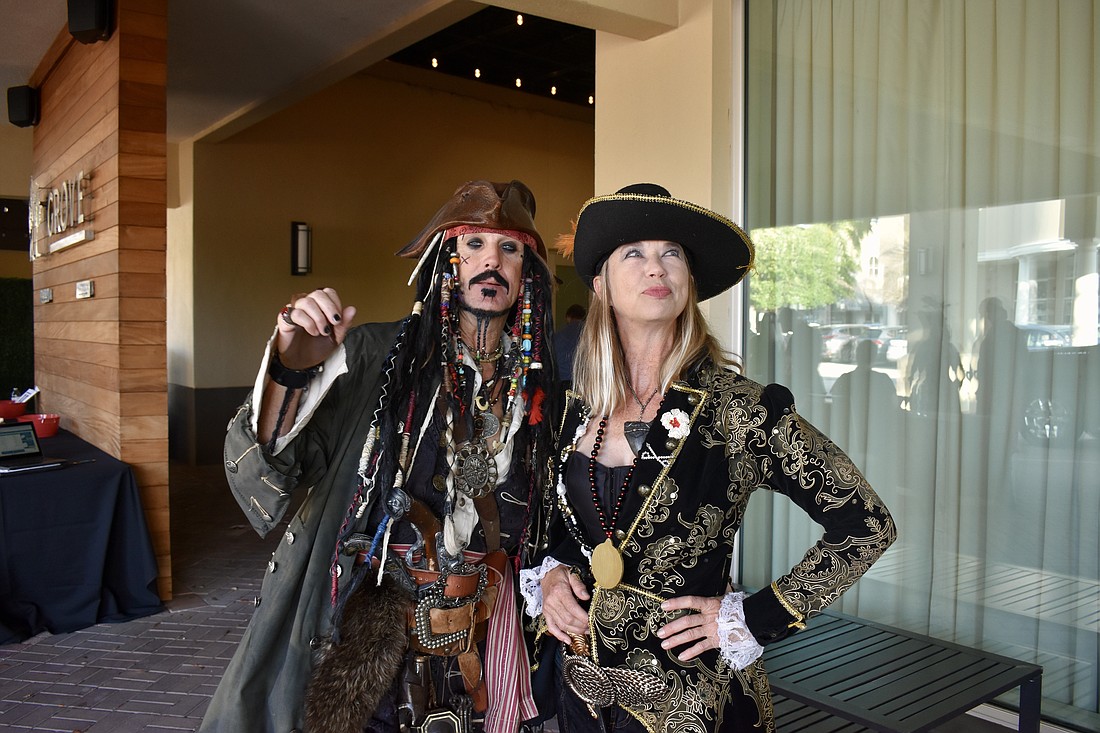 Stuart Hales and Ava Lasseter greet guests at Tropical Nights on March 23.