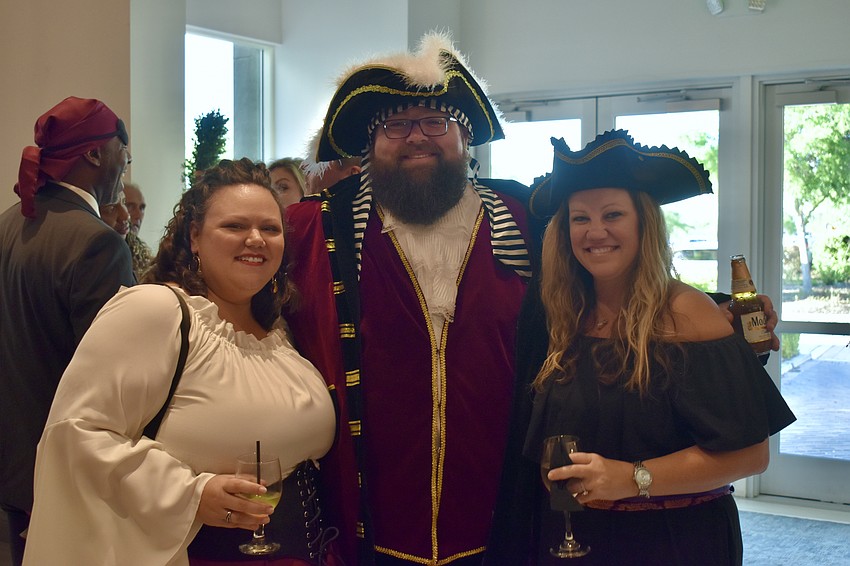 Bradenton residents Mallory and Chad Metcalf attend Tropical Nights with Meals on Wheels Plus board member Christi Bock.