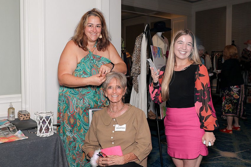 Erin Sleezer from Fantasy Flair gives Margo Bischof 'fairy hair' while Sydney Wolf snaps some photos