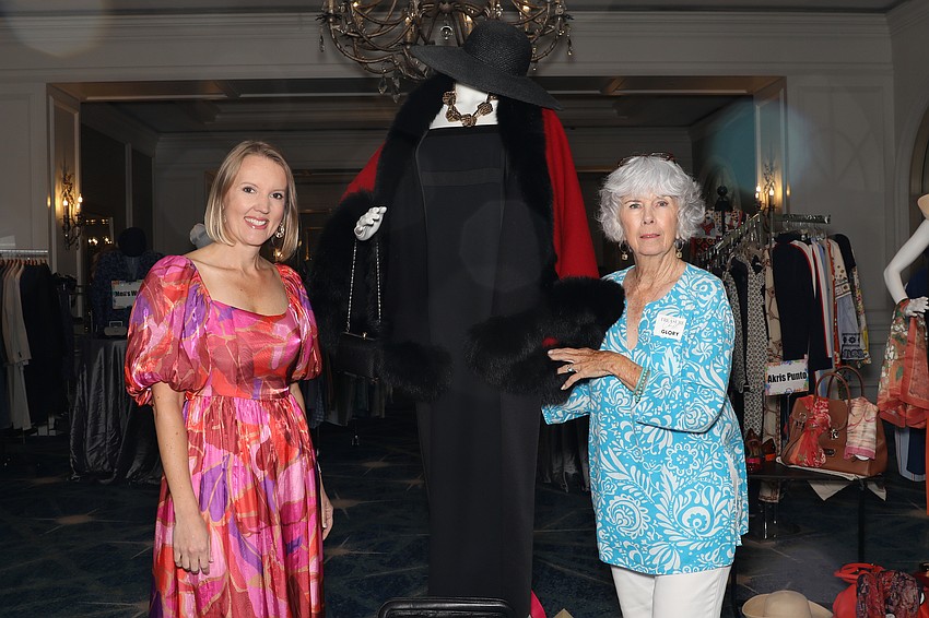 SPARCC President and CEO Jessica Hays and Glory Slupe admiring a Yvonne LaFleur Cape and Laundry by Shellli Segal dress that are for sale.