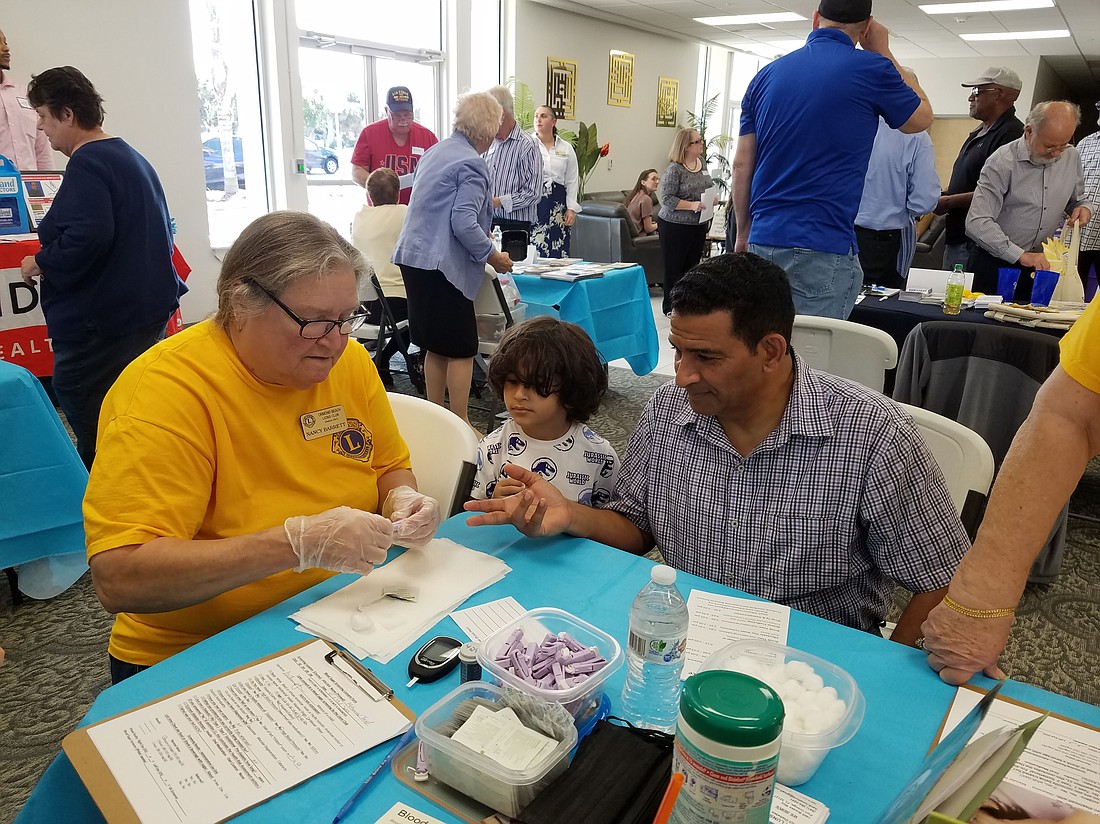 Nancy Barrett of the Ormond Beach Lions Club performs a free diabetes screening at the Interfaith and Community Resource Network's winter Sharing Conference on Jan. 28, at the Islamic Center in Daytona Beach. Courtesy photo