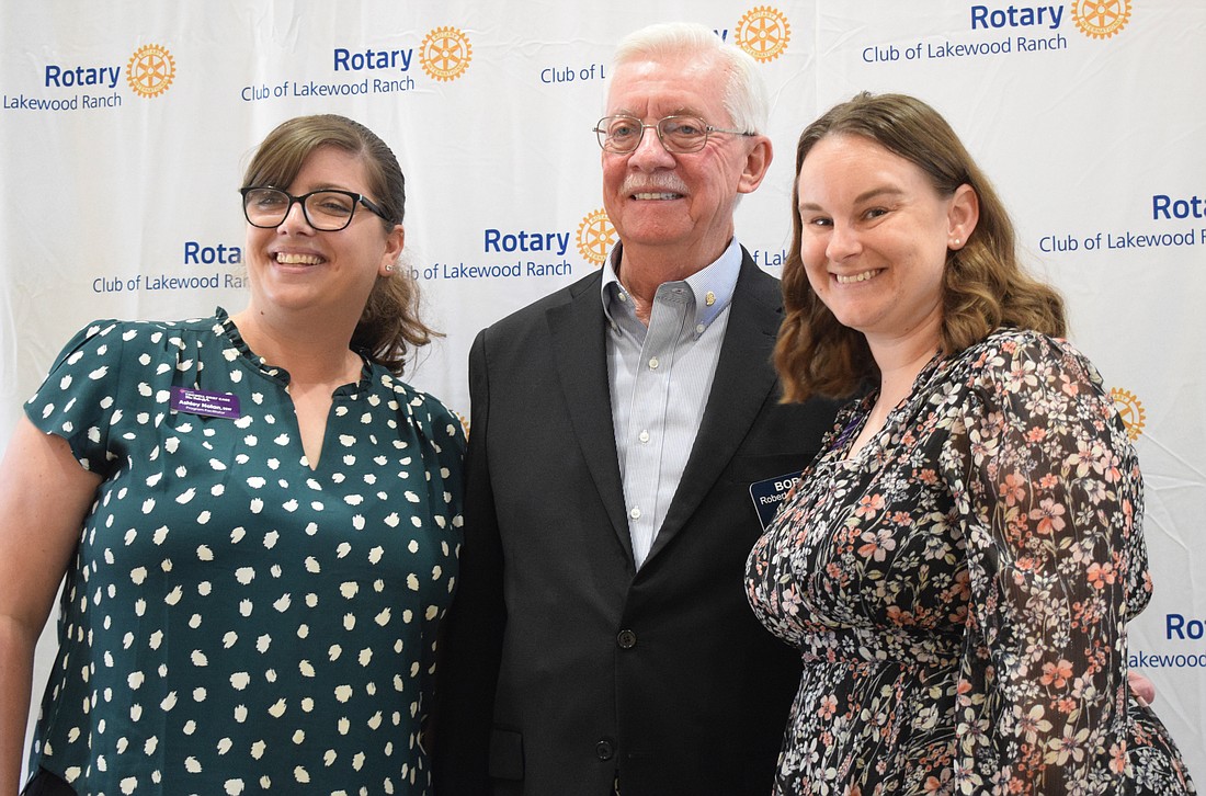 Ashley Nolan and Megan Wenger with the Tidewell Foundation are thankful for the grant Rotary Club of Lakewood Ranch member Bob Grepling presented to them for Tidewell Foundation's Blue Butterfly program.
