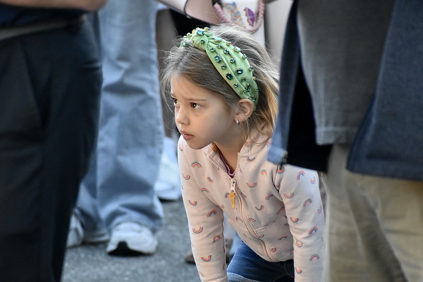 Eleanor Bauer, 4, watches a speaker at one of the stations.