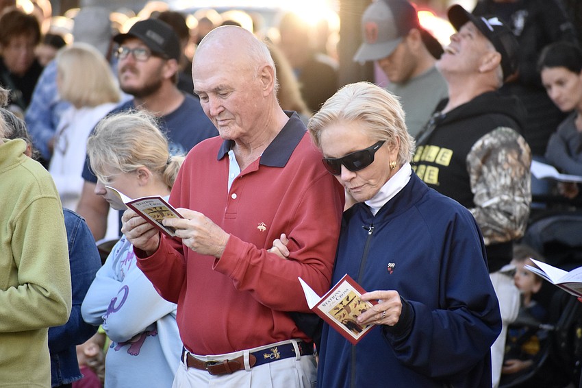 Dave and Nancy Morgan follow along with the event through their booklets.