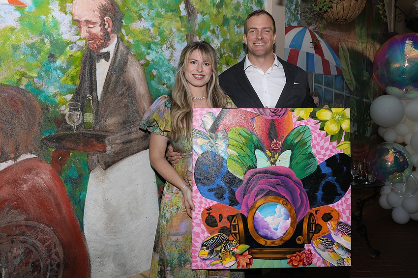 Southside Elementary art teacher Amber Richter, and her husband, Jimmy, hold the whimsical mixed media piece that Amber created for the silent auction.