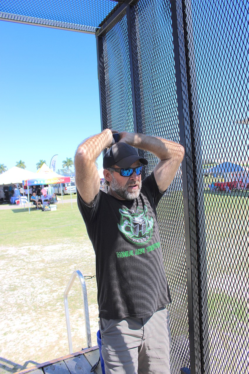 Greg Garrison displays how to properly throw an axe at his 