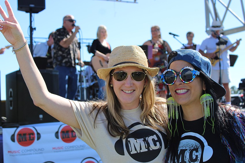 Music Compound's Jenny Townsend and Alyssa Martin celebrate their students being on stage during Musicpalooza Friday at Nathan Benderson Park. the event was a lead-in to Saturday's My Hometown Fest.