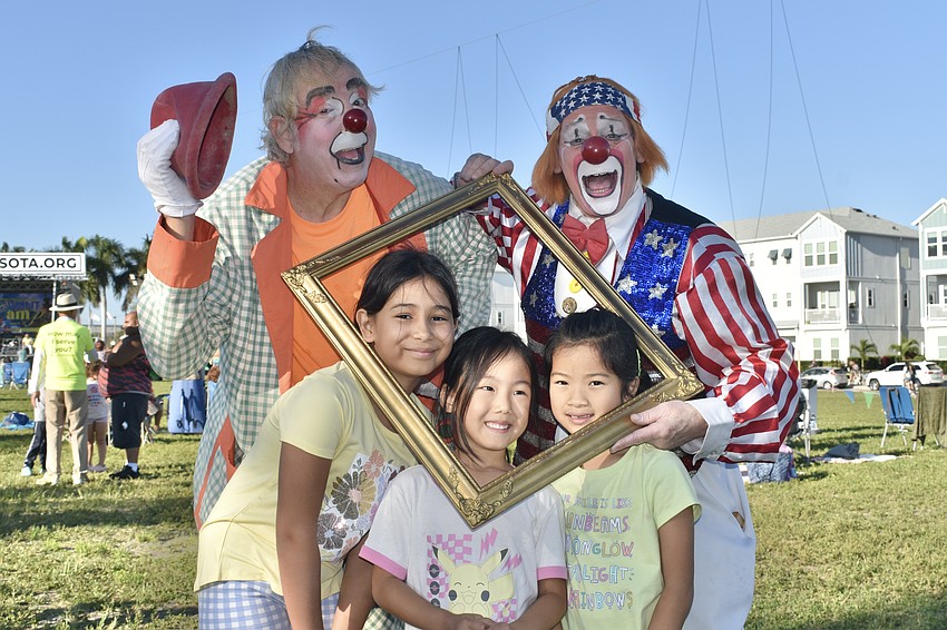 J-P the Clown, Heloisa Camara, 9, Dora Yu, 7, and Gabriella Pan, 4 and ChuckO