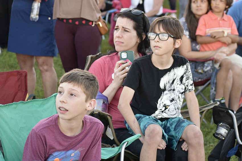 Levi Morris, 11, Kristin Morris and Silas Morris, 9 watch Nik Wallenda walk the tightrope.