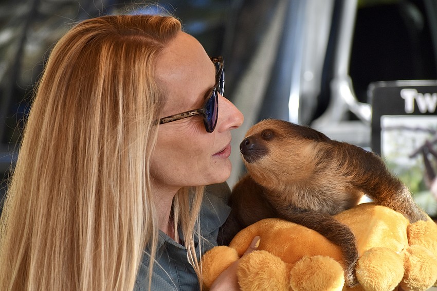 Danielle Rosaire showcases Dash the sloth.