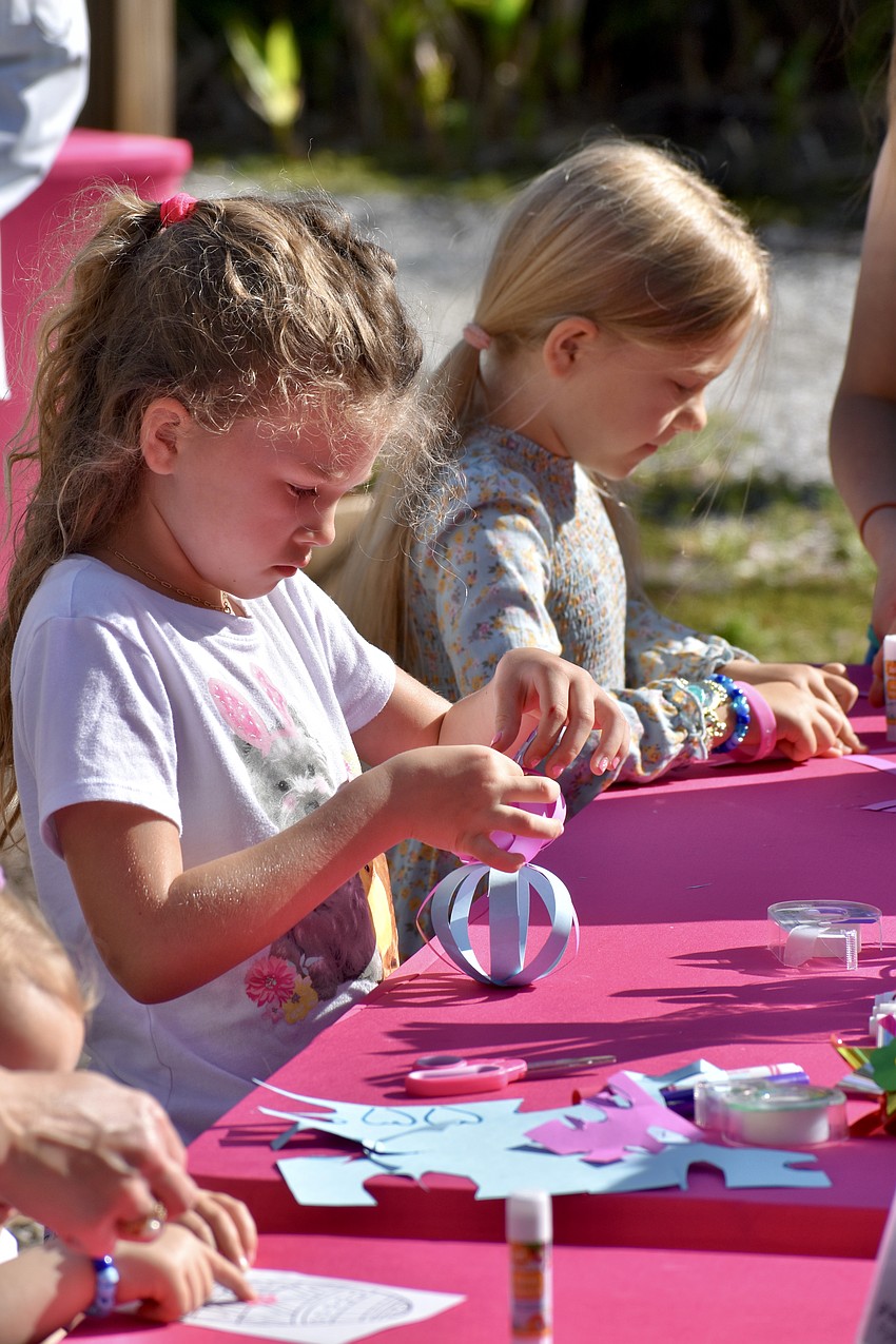 Ava Peterman, 6 and Brooklyn Layman, 5 work on a paper Easter Bunny craft.