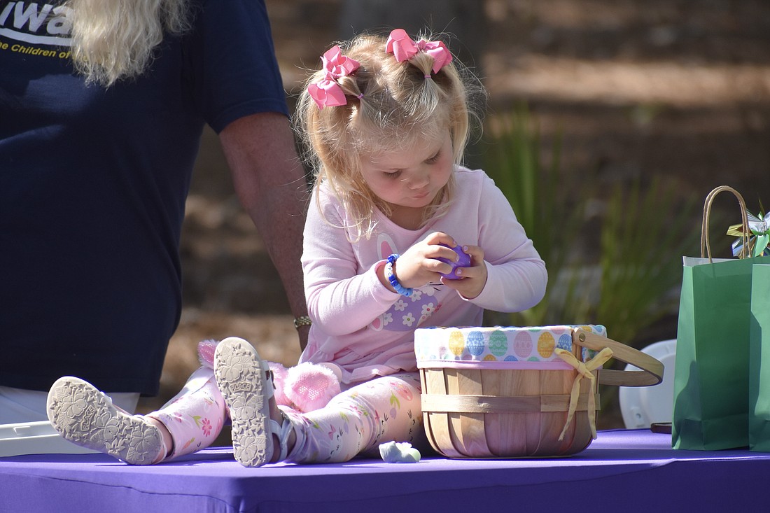 Isabelle Urfer, 3, sorts through Easter eggs.