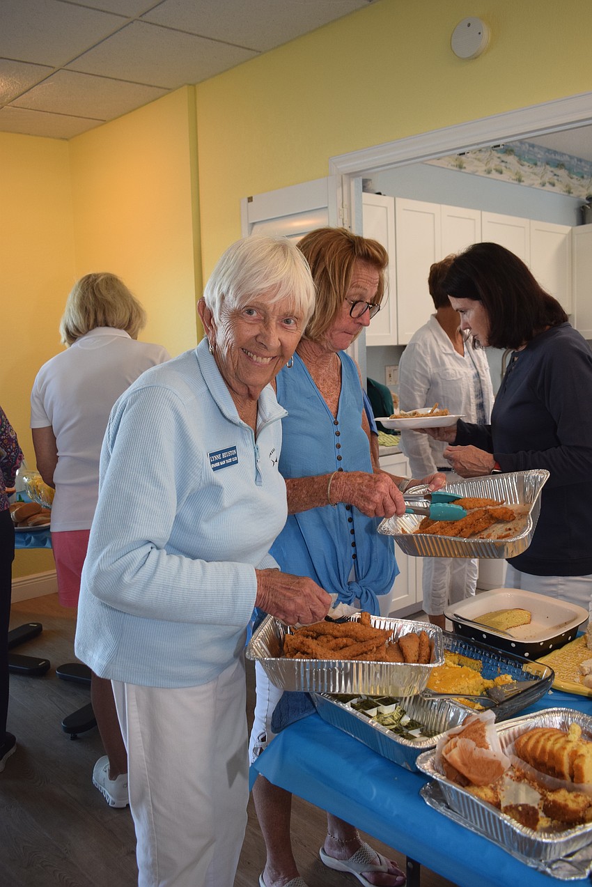 Lynn Heuston serving fish at Spanish Main Yacht Club's Fish Fry