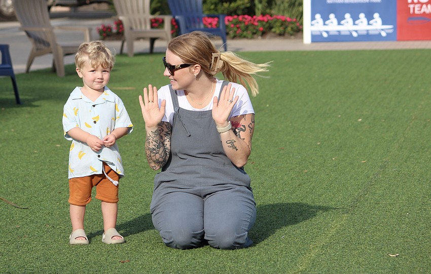 Sarasota resident Axil Powers gets encouragement to join in from his mom, Sutherlan Powers.