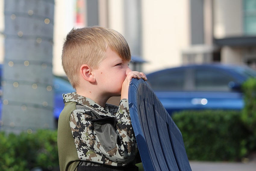 Dressed as a soldier, 4-year-old Abram Glass secretly assesses the situation before entering the play circle.