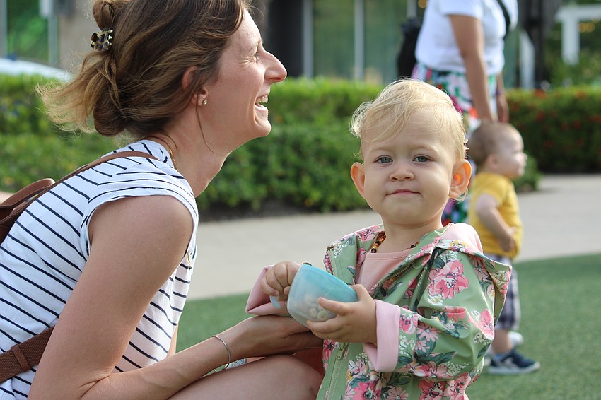 Luna Frank, 1, takes a snack break with mom Sophia.