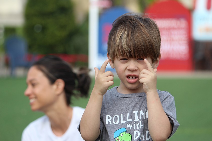Olin Croce, 3, pretends to take a picture.
