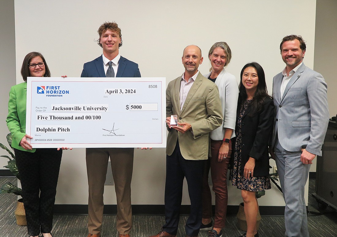 From left, Barbara Ritter, dean of the Jacksonville University Davis College of  Business & Technology; 2024 Dolphin Pitch first-place winner Liam Wheeler; and Dolphin Pitch judges Mark Price, vice president and senior business banking relationship manager, First Horizon Bank; Kate McAfoose, Chang Industrial president; Claudia Pak, brand manager, Haymaker Coffee Co.; and Maarten Rotman, Mayo Clinic in Florida entrepreneurial education manager.