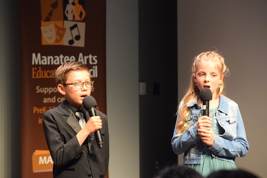 Braden River Elementary School's Alessandro Hernandez and Palma Sola Elementary School's Nora Green perform the National Anthem.