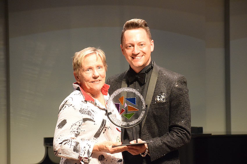 Carla Nierman, the executive director of ArtCenter Manatee, accepts the Herbie Rose Arts Innovation Award from Jeramiah Bowman, the chairperson of the Manatee Arts Education Council.