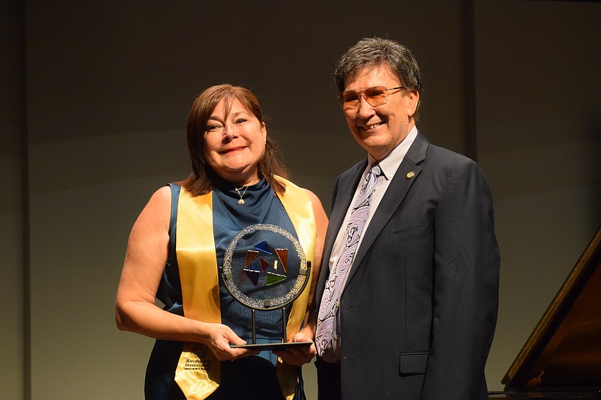 Samantha Cummins accepts the Vernon DeSear Arts Champion Award from Vernon DeSear.