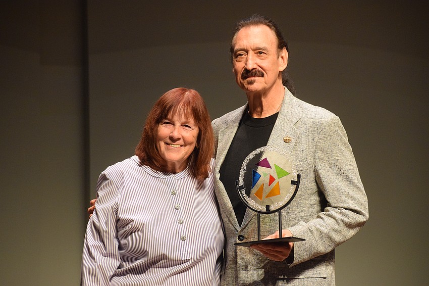 Linda Boone presents the Linda Boone Dance Education Award to Craig Thomas, who accepted the award on behalf of his wife, Ellen Meade. Meade died in August 2023.