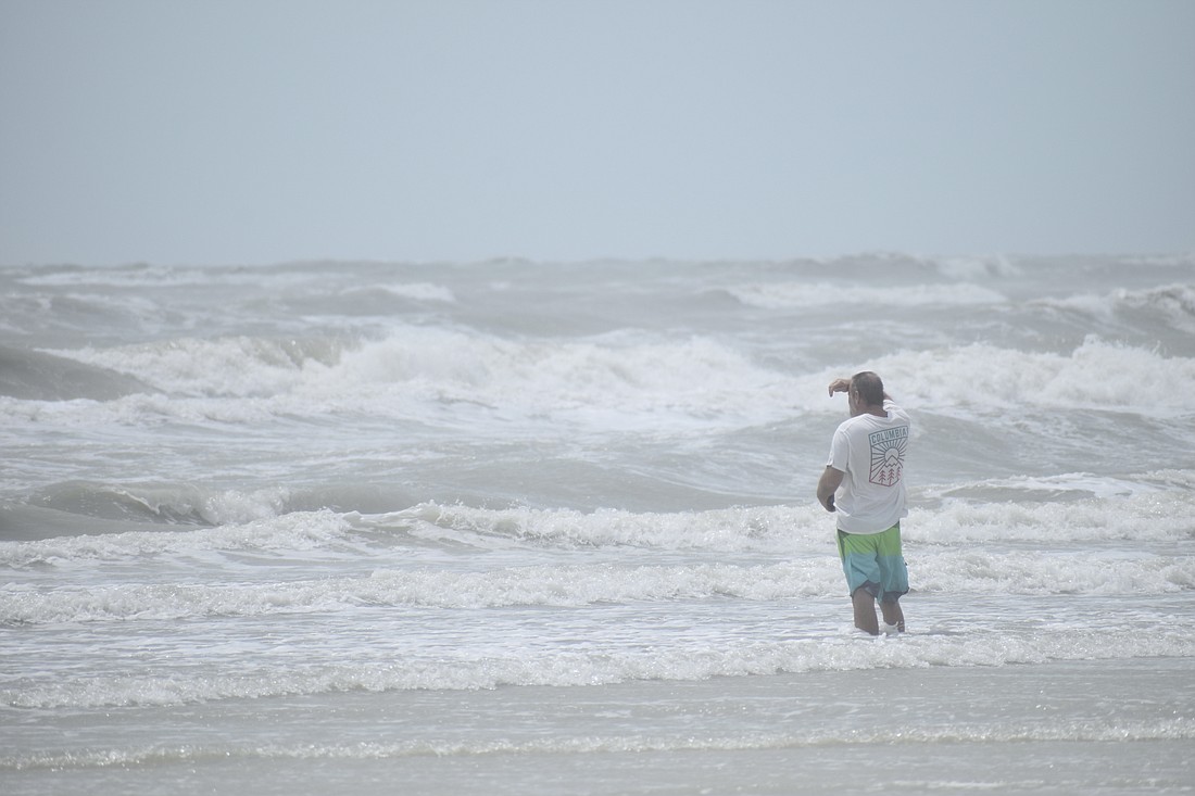 Michael Gregory looks out at the rough seas from Siesta Key Beach after Hurricane Idalia on Aug. 30, 2023.