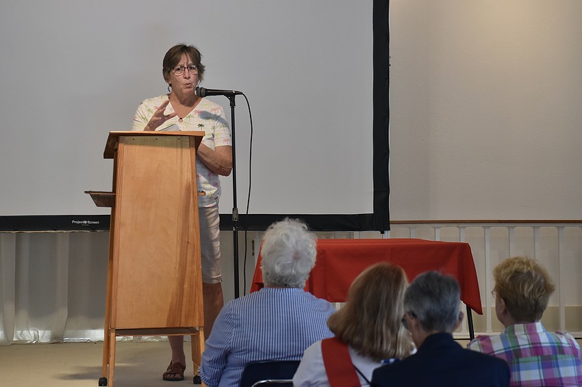Lorrie Muldowney, president of the Sarasota Alliance for Historic Preservation, delivers a speech inside the Crocker Memorial Church.