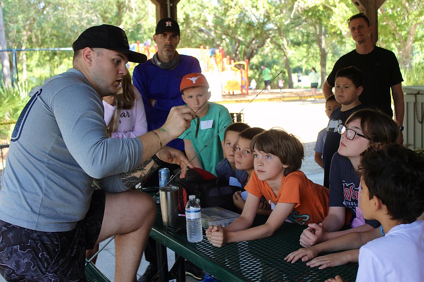 Captain Nick Limoncelli teaches the kids about tackle.