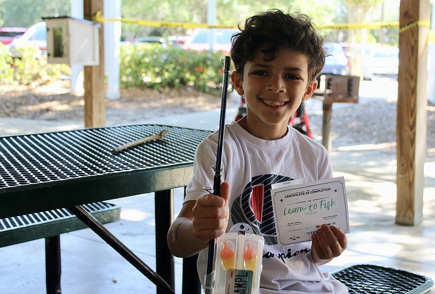 Third grader Aksel Soares learned how to tie knots for the first time during the seminar. He earned both a Learn to Fish certificate and a new fishing pole for his efforts.