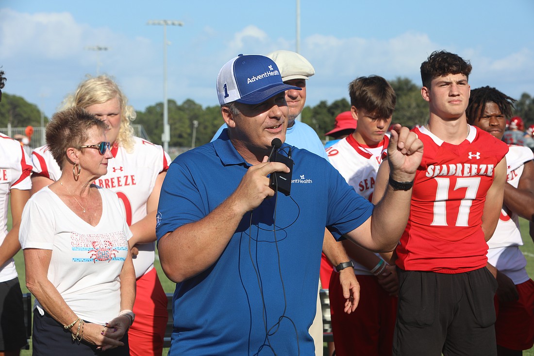 Erik Nason, AdventHealth's manager of sports medicine for Volusia and Flagler counties, speaks about the importance of health and ECG screenings before a JV football game last August with Seabreeze athlete Brogan Kelly (17) looking on. File photo by Brent Woronoff